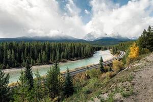 Railway with rocky mountains and cloudy in autumn valley at Morant's Curve photo