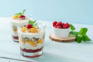 homemade mango and raspberry with yogurt and granola photo