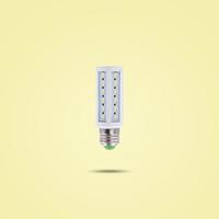 LED energy saving lamp 230v isolated on yellow pastel color background. photo