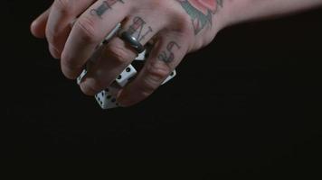 Tattooed hand dropping dice in slow motion shot on Phantom Flex 4K at 1000 fps