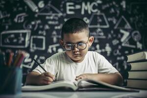 A boy with glasses man writing in the classroom photo