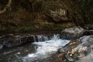 Waterfall in the nature and stone background photo