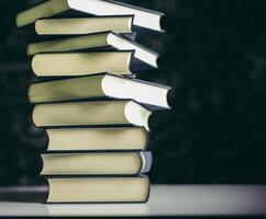 The books are placed in a stack of books on the table photo