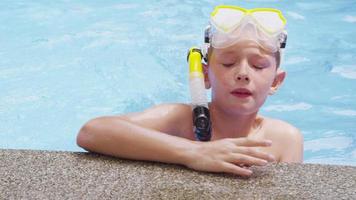 retrato de menino na piscina com equipamento de snorkel. filmado em vermelho épico para alta qualidade 4k, uhd, resolução ultra hd. video