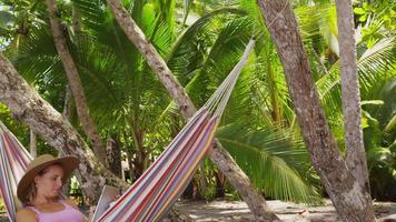 Woman sitting in hammock using digital tablet, Costa Rica. Shot on RED EPIC for high quality 4K, UHD, Ultra HD resolution. video