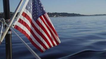 American flag waves on back of sailboat. Shot on RED EPIC for high quality 4K, UHD, Ultra HD resolution. video