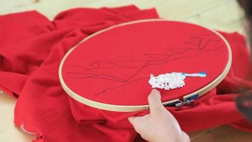 Embroider sewing by woman hand. Craft work and female hands. photo