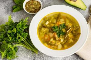sabrosa sopa de verduras y especias sobre un fondo de hormigón gris. se puede utilizar como fondo foto