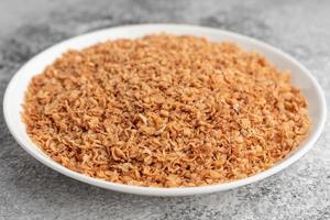 Buckwheat cereal in a white saucer on a gray concrete background photo