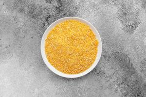 Cornmeal mush in a white saucer on a gray concrete background photo