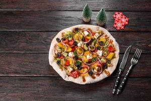 Tasty fresh salad prepared for the Christmas table photo