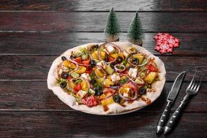 Tasty fresh salad prepared for the Christmas table photo