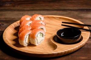 Various kinds of sushi served on a dark background photo