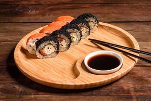 Various kinds of sushi served on a dark background photo