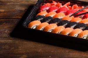 Various kinds of sushi served on a dark background photo