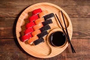 Various kinds of sushi served on a dark background photo