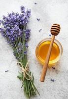 Jar with honey and fresh lavender flowers photo