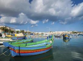 maltese traditional painted luzzu boats in marsaxlokk fishing village malta photo