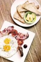 traditional english british fried breakfast with eggs bacon and sausage photo
