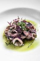 Ensalada de calamar marinado con mariscos frescos tradicionales portugueses en aceite de cilantro