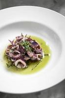portuguese traditional fresh seafood marinated squid salad in coriander oil photo