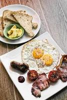 traditional english british fried breakfast with eggs bacon and sausage photo