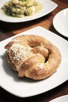 vegan dairy-free organic german pretzel bread on wood table photo