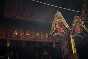 Bobinas de incienso encendidas tradicionales dentro del templo chino a-ma en macao foto