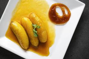 flambeed fried banana in orange reduction and tangerine caramel photo