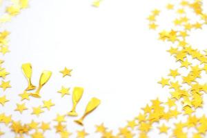 Festive background. Shining confetti stars on white background. Christmas. Wedding. Birthday. photo