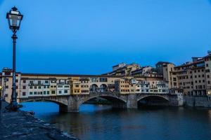 Sunset on Ponte Vecchio - Old Bridge - in Florence, Italy. Amazing blue light before the evening. photo