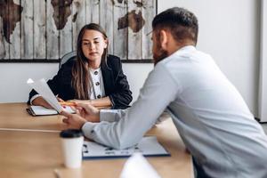 Young business man shows the results of work to his manager. Work in the office photo