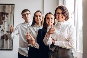 Businesspeople showing thumb up photo