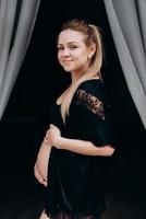 Smiling pregnant woman posing in studio photo