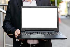 Closeup image of businessman holding open laptop, empty white blank screen- Image photo