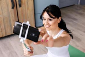 Smiling girl is photographed on her smartphone photo