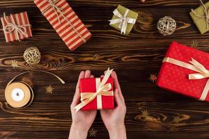 Gifts on wooden background, top view photo