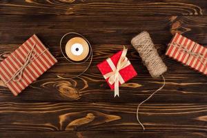 Gifts on wooden background, top view photo