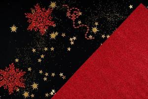 Festive red and black Christmas background with sequins and snowflakes photo