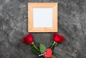 Celebrate Valentine's day. Red roses, heart sign,on grey background top view copy space photo