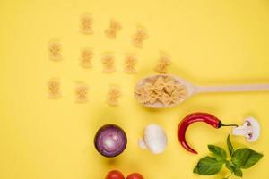 Italian food or ingredients background with fresh vegetables, pasta, cheese parmesan and spices. Top view, view from above. Copy space. photo