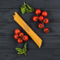 Tomatoes, basil, spaghetti. Top view. Concept of Italian cuisine. photo