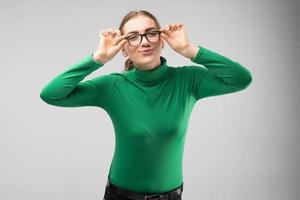 Girl teenager in glasses and in modest clothes have fun - play the ape.- Image