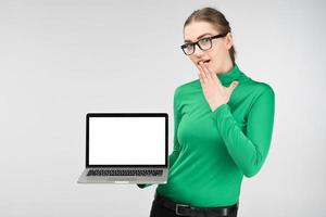 Student girl holds a laptop in her hands and surprised . - Image photo