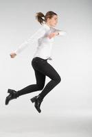 Happy smiling young woman jumping in air - people concept image photo