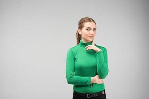 Young girl standing is thoughtful in the studio. - Image photo