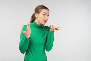 Surprised  young woman talking on a cell phone holding it in her hands.- Image photo