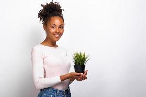 Half-turn portrait girl with grass pot in her hands. Concept World Environment Day photo