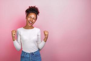 mujer emocionada hace las manos con los puños cerrados en gesto ganador en estudio. gesto de concepto - imagen foto