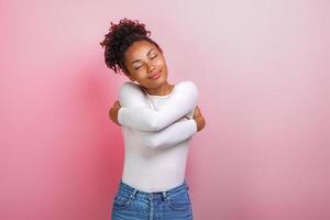 Cute woman hugging herself feeling a comfort, calmness and love. Concept gesture - Image photo